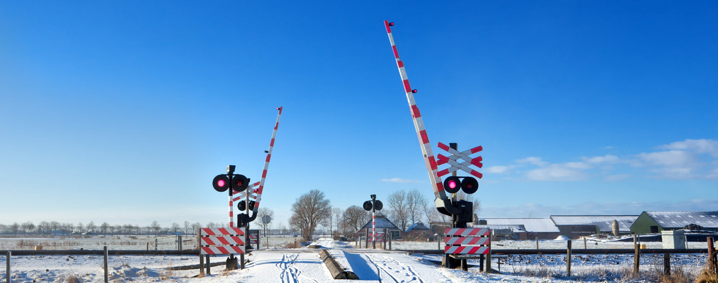 crorring through railway with red sygnal lights in winter